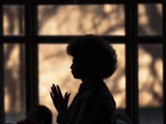 alt="image showing black woman in a church"