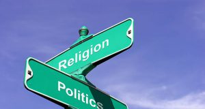 alt="image showing signpost with the words religion and politics"